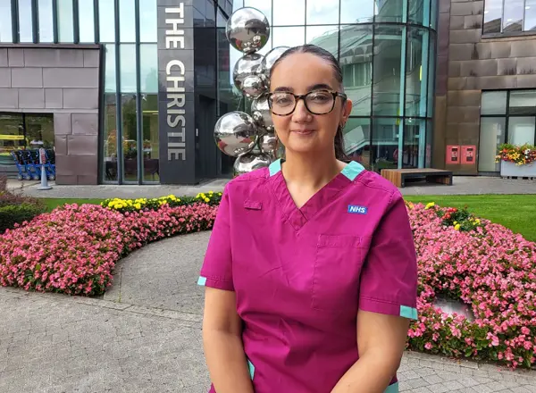 A photo of Christie radiographer Suzanne Lagan standing outside the main entrance to The Christie.
