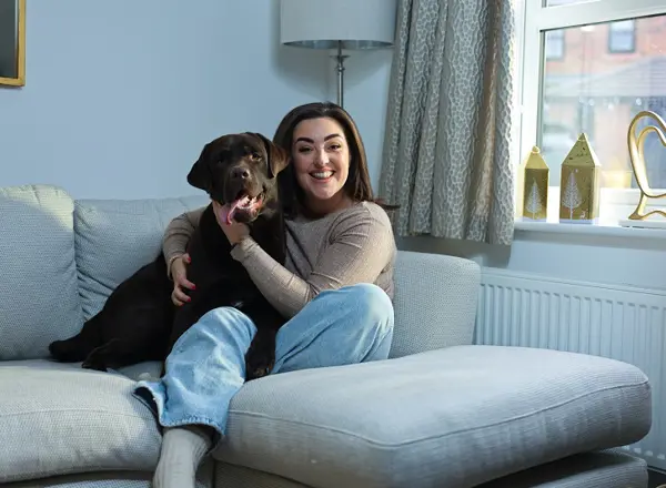A photo of Christie patient Bianca Perea with her labrador dog Cubby.